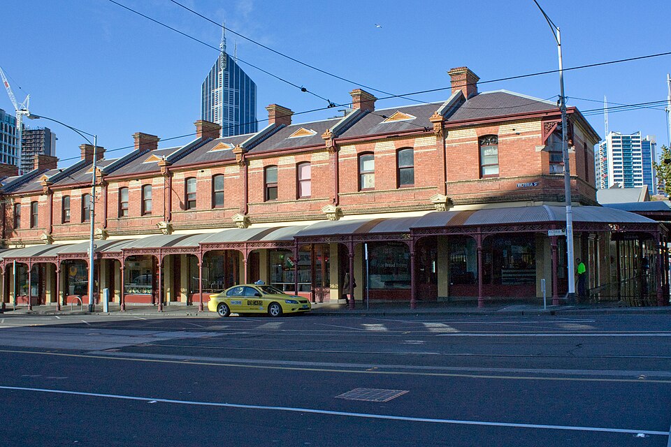 Brick shopfronts with awnings on Victoria Street at Queen Victoria Market.