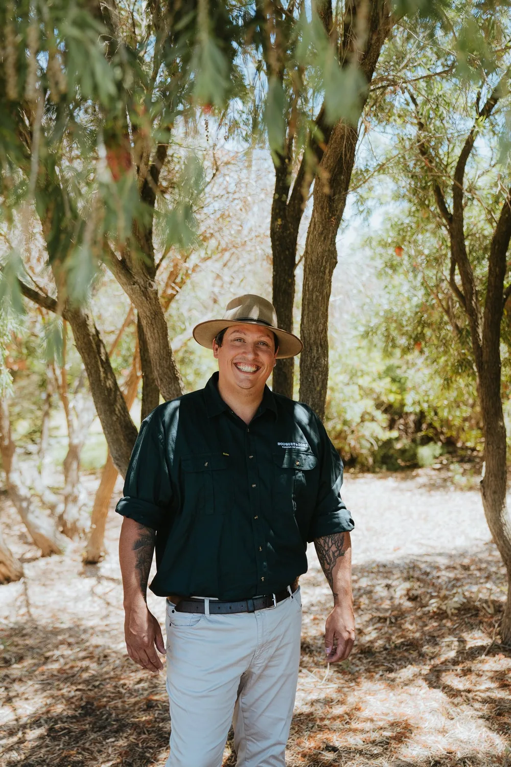 A person beside trees in the pet-minding collection.