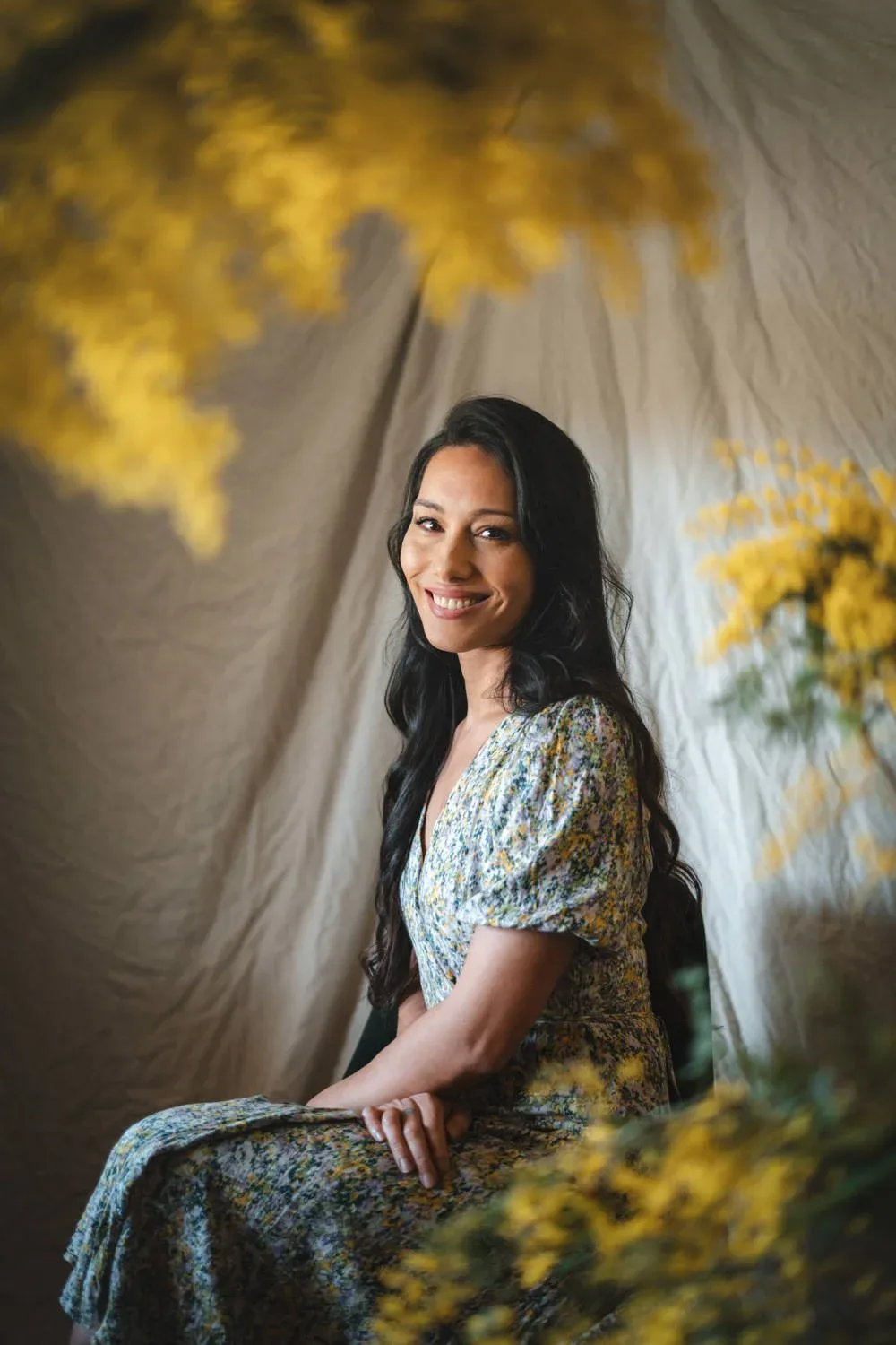 A direct author portrait framed by flowers.