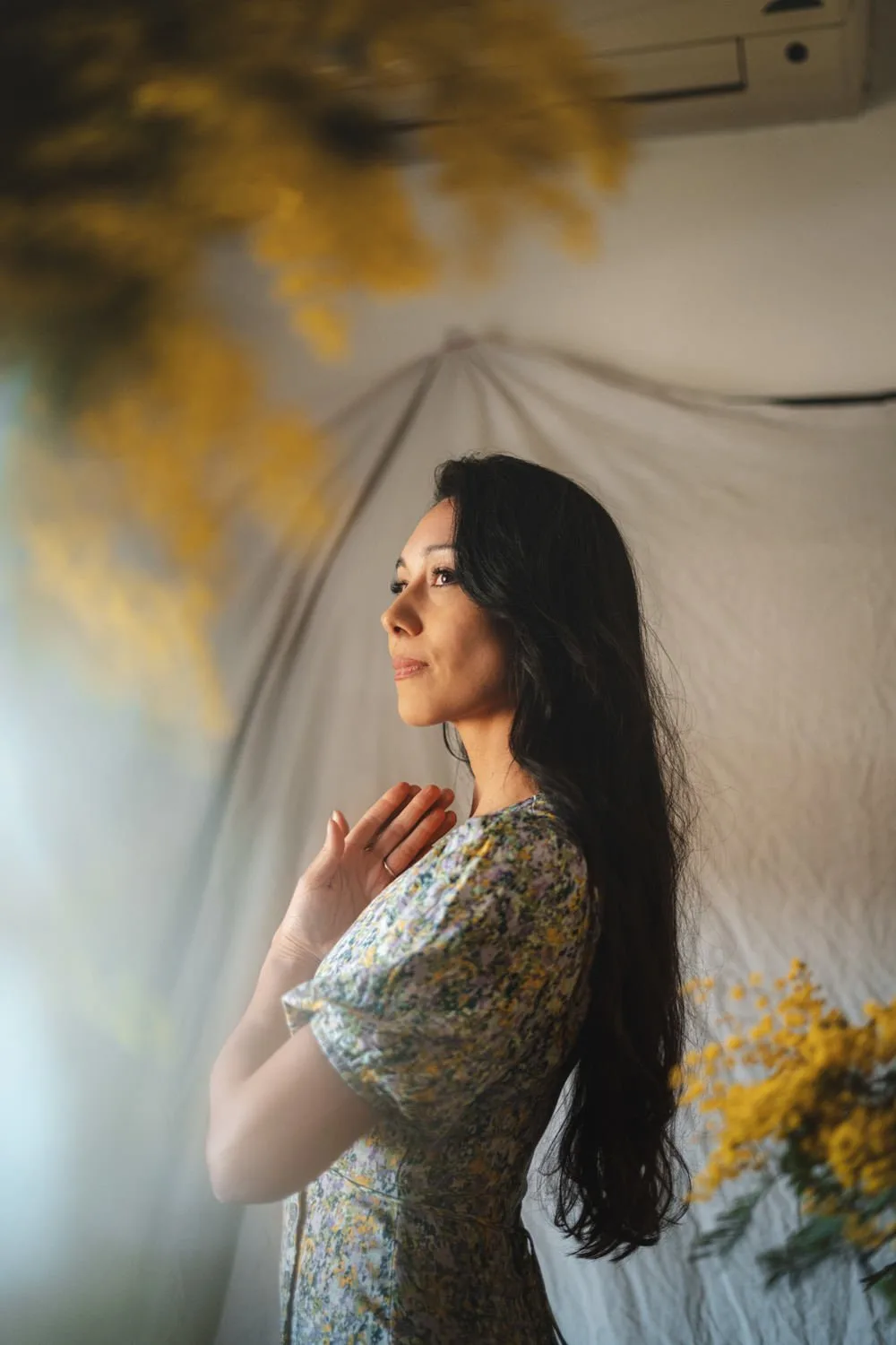 A close portrait with yellow blossom at the edge of the frame.