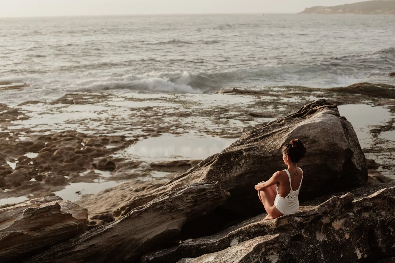 A figure beside the sea in the project imagery.