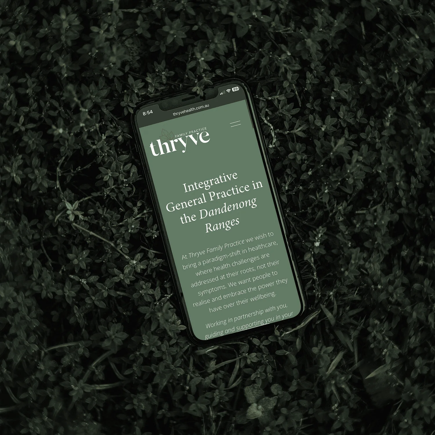 Thryve Family Practice’s green website design displayed on a phone.
